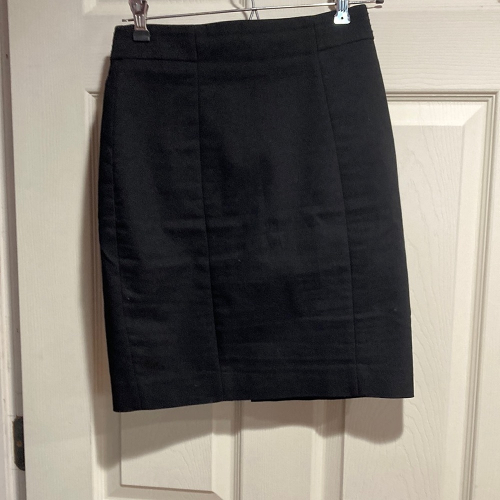 H&M size 2 black pencil mini skirt with a small slit up the back.  Zips up.
